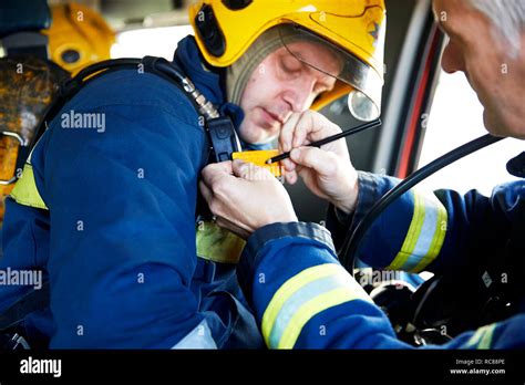 Fireman inside fire engine Stock Photo - Alamy