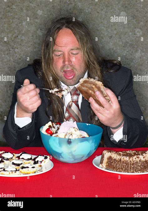 Long haired fat man eating stuffing himself with cake and ice cream Stock Photo: 4414092 - Alamy