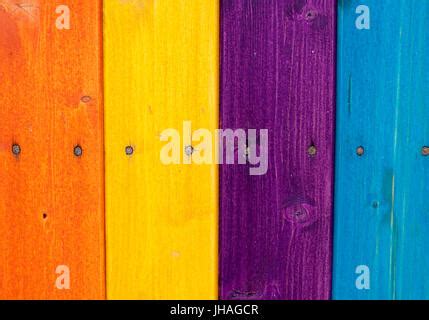 Multi colored rainbow wooden fence in autumn, garden background, soft focus, shallow depth of ...