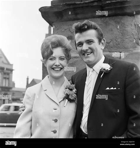 Liverpool goalkeeper Tommy Lawrence poses with his 19 year old bride Judith price after their ...