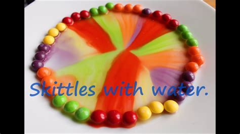 Skittles rainbow experiment with milk and water - YouTube