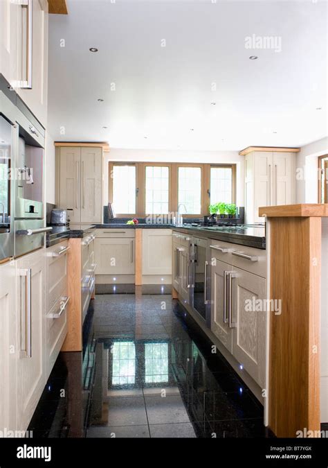 Black granite flooring in large modern kitchen extension Stock Photo ...