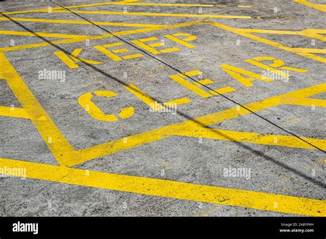 Keep Clear sign in large yellow letters on concrete pavement Stock ...