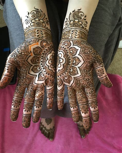 the hands are decorated with henna designs