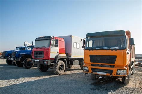 Premium Photo | A row of large dump trucks and machines at a ...