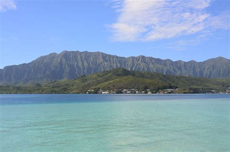 the mountains are in the distance over the water