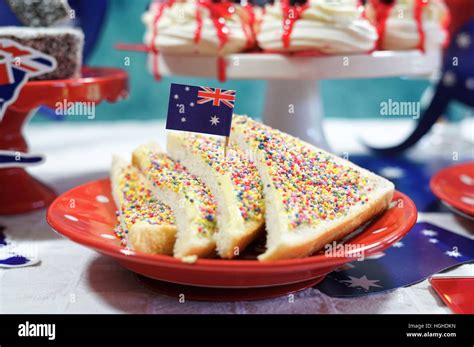 Australian theme party table with flags and iconic food including mini pavlovas, lamingtons ...