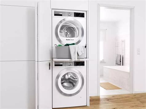 a washer and dryer stacked on top of each other in a white room