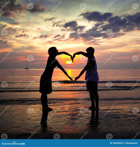 Young Couple Holding Hands Heart-shaped At Sunset Royalty Free Stock Image - Image: 28055826