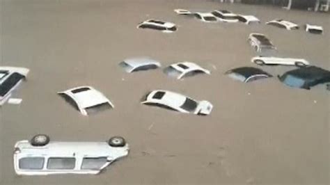 China flooding: Cars float down flooded road in Zhengzhou | World News | Sky News