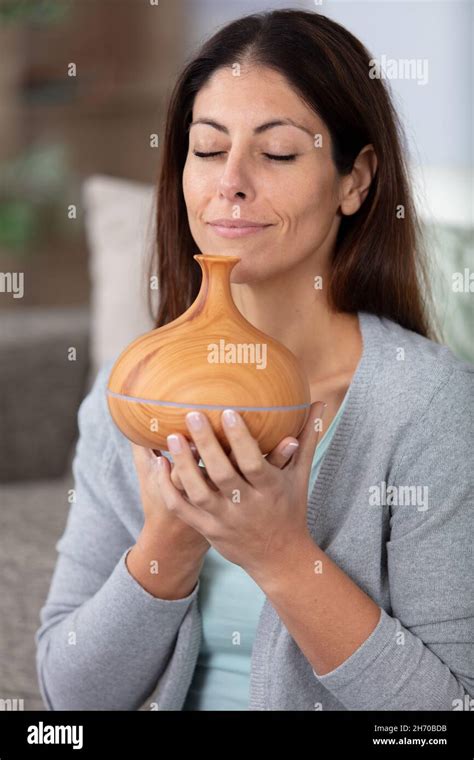 woman smelling essential oil diffuser Stock Photo - Alamy