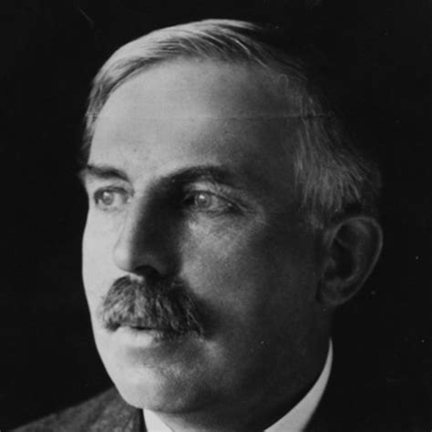 an old black and white photo of a man in a suit with a moustache