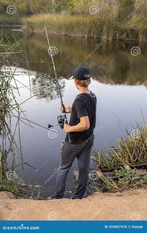 Teenage Boy Fishing at the Lake Stock Photo - Image of nature, reflection: 259007976