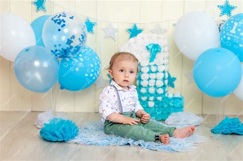 Premium Photo | Baby boy celebrates 1 year with cake and balloons ...