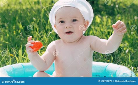 Emotional Little Boy the Baby is Bathed in an Inflatable Pool and Having a Laugh Stock Footage ...