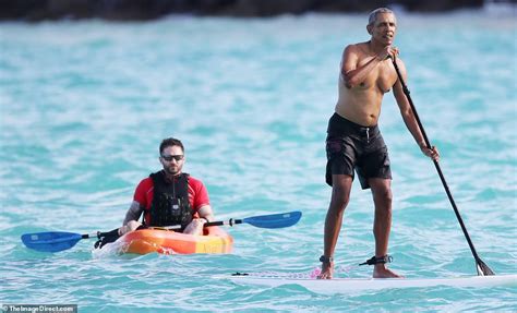 Shirtless Barack Obama is pictured paddleboarding in Hawaii - ReadSector