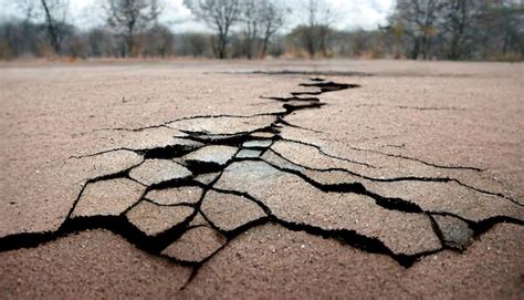 Premium Photo | Ground cracks breaks on land surface from earthquake