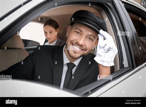 Handsome chauffeur driving luxury car Stock Photo - Alamy