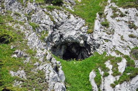 Small cave entrance in the mountains Stock Photo by ©salajean 49220397