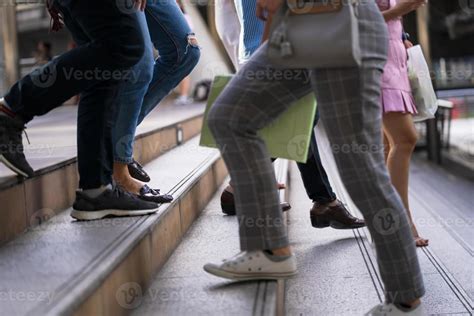 Close-up of people's feet walking on stairs 1978949 Stock Photo at Vecteezy