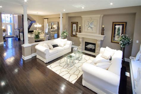 Dark flooring contrast nicely with the beige pallet and white furniture ...