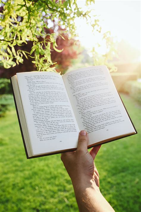 Royalty-Free photo: Man reading a book outdoors | PickPik