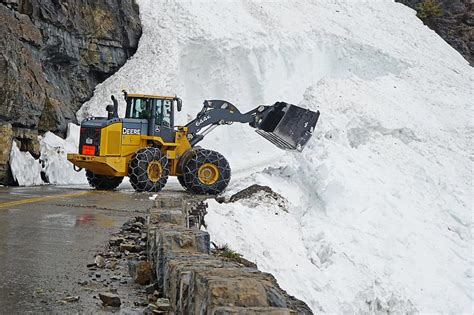 See the Mountains of Snow Being Cleared in Glacier National Park