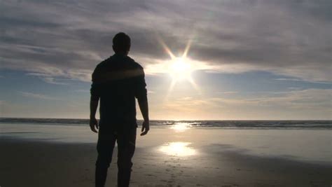 Silhouetted Man Walks Out On Beautiful Sandy Beach Near Sunset At The Oregon Coast. Stock ...