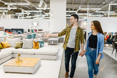 Premium Photo | Happy couple choosing furniture in store showroom. man ...