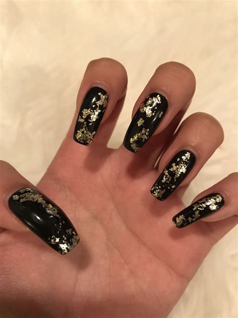 Black nails with gold flakes | Black gold nails, Gold nail designs, Black acrylic nails