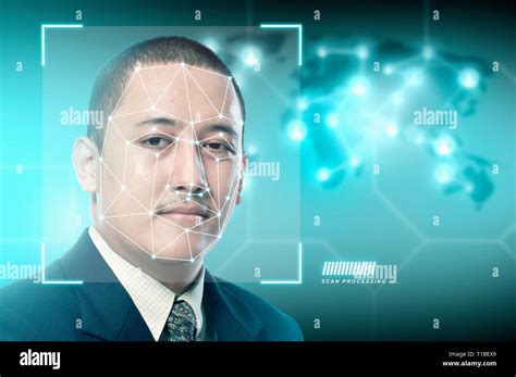 Handsome asian businessman using face recognition over digital world map background. Modern ...
