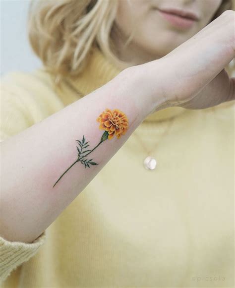 Yellow Marigold tattoo by tattooist picsola - Tattoogrid.net