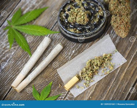 Cannabis Joints with Rolling Paper and Grinder Stock Photo - Image of cannabinoids, close: 130933160