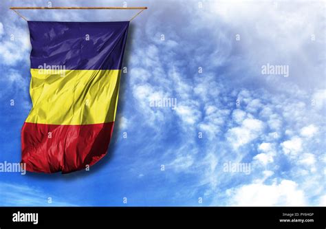 Flag of Romania. Vertical flag, against blue sky with place for your text Stock Photo - Alamy