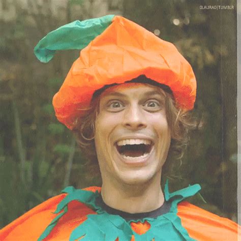 a man in an orange and green costume is making a funny face with his ...