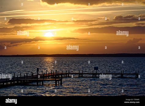 Sunset on the sea and Jetty Stock Photo - Alamy