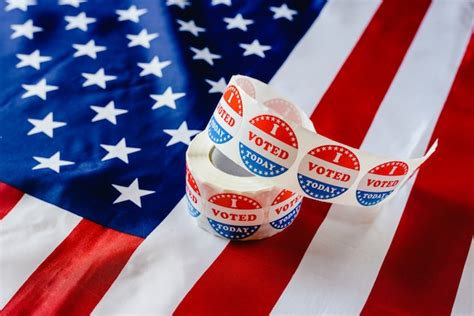 Premium Photo | I vote today stickers roll, in us elections on american flag.