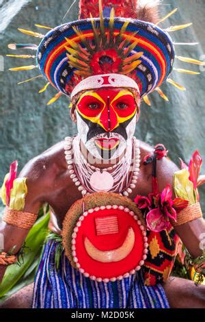 Tribesman in Papua New Guinea playing a bamboo flute Stock Photo - Alamy