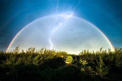 Picture taken after a storm. a lightning appeared while I was photographing the double rainbow ...