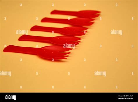 Five small plastic red disposable forks isolated on pastel color background close up Stock Photo ...