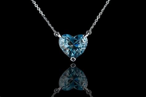 Premium Photo | Beautiful pendant with aquamarine with a gold chain on a black background