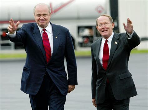 two men in suits and ties are walking down the street with their hands ...