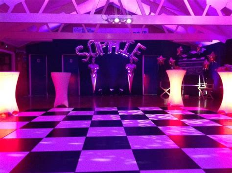 Checkered dance floor with glow-in-the-dark high top tables...party by ...