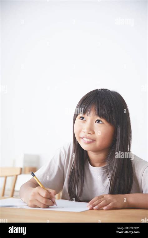 Girl Studying at Dining Table Stock Photo - Alamy
