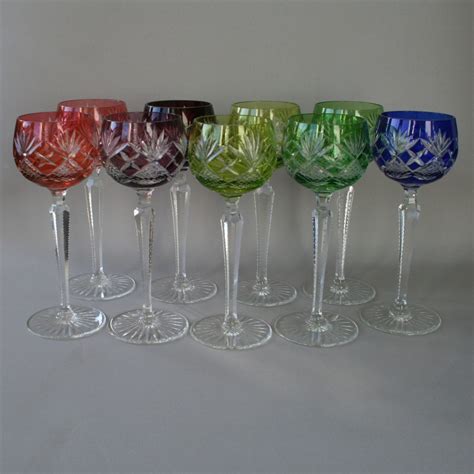 A set of nine multi coloured cut glass crystal hock or wine glasses ...