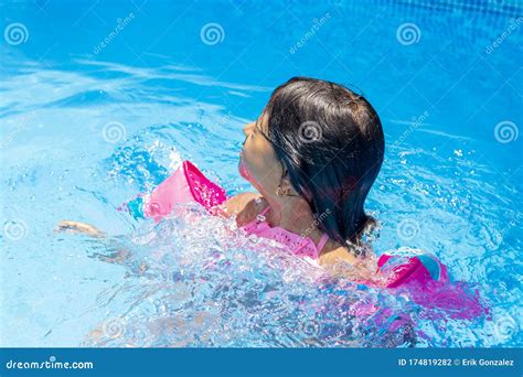 Little Girl Swimming with Floaties Stock Photo - Image of playing, feminine: 174819282