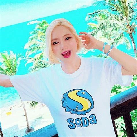 Blonde Woman in Soda T-Shirt on Balcony by the Ocean