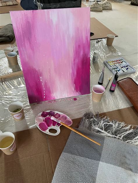 a painting is being displayed on a table with paint and other art ...