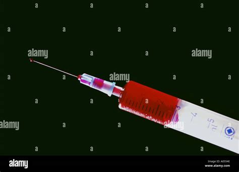 medicine injection with red serum Stock Photo - Alamy