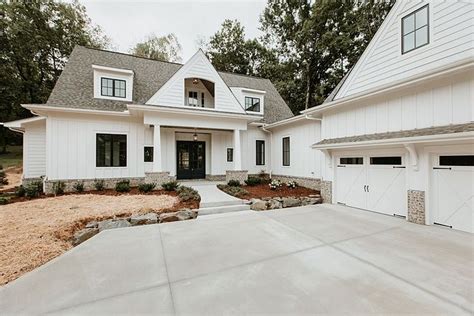 a large white house with two garages